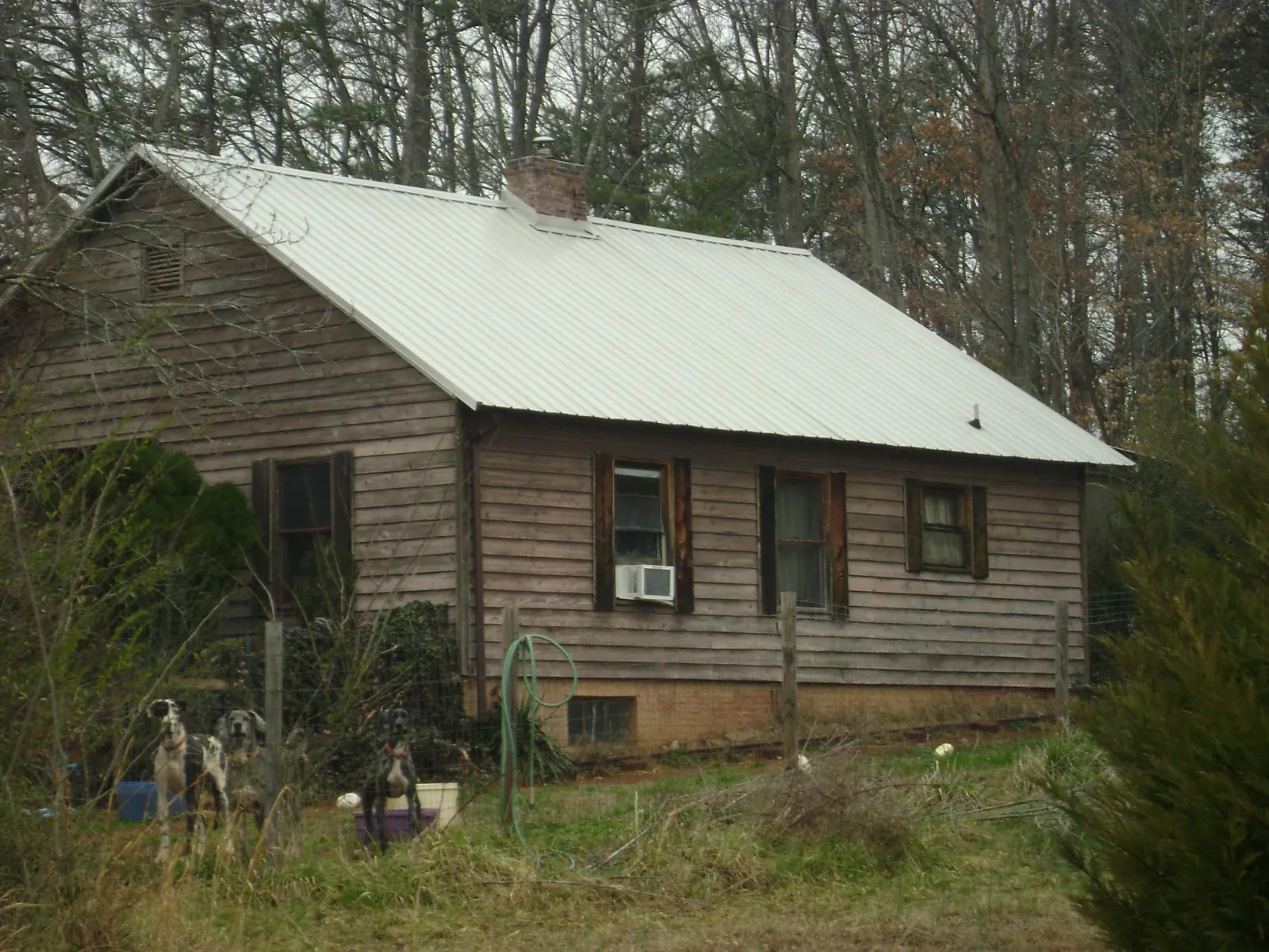 White metal roof on an old wood sided farmhouse, from a Metal Roof Installation job in Lometa